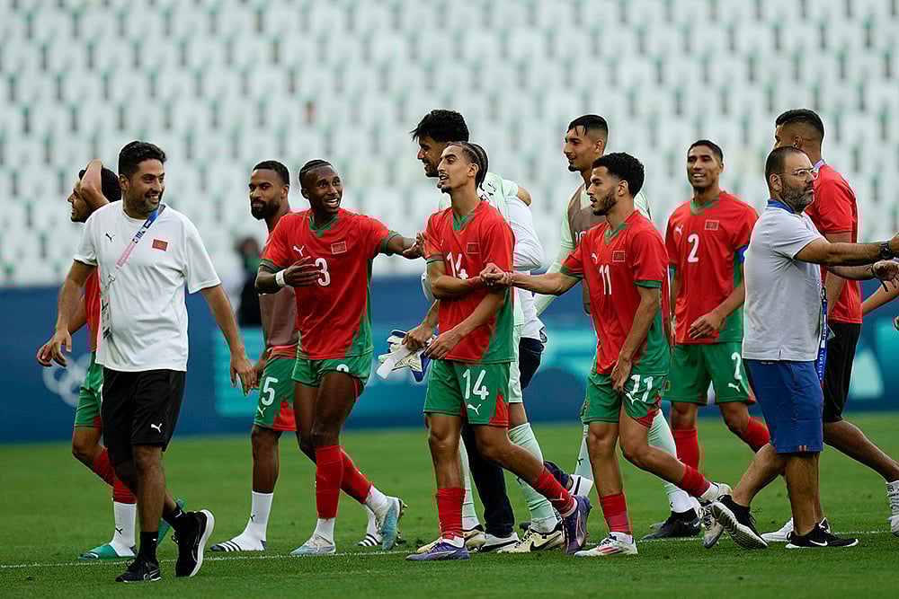 | Photo: AP/Silvia Izquierdo : Morocco's players celebrate at the end match. Morocco won 2-1